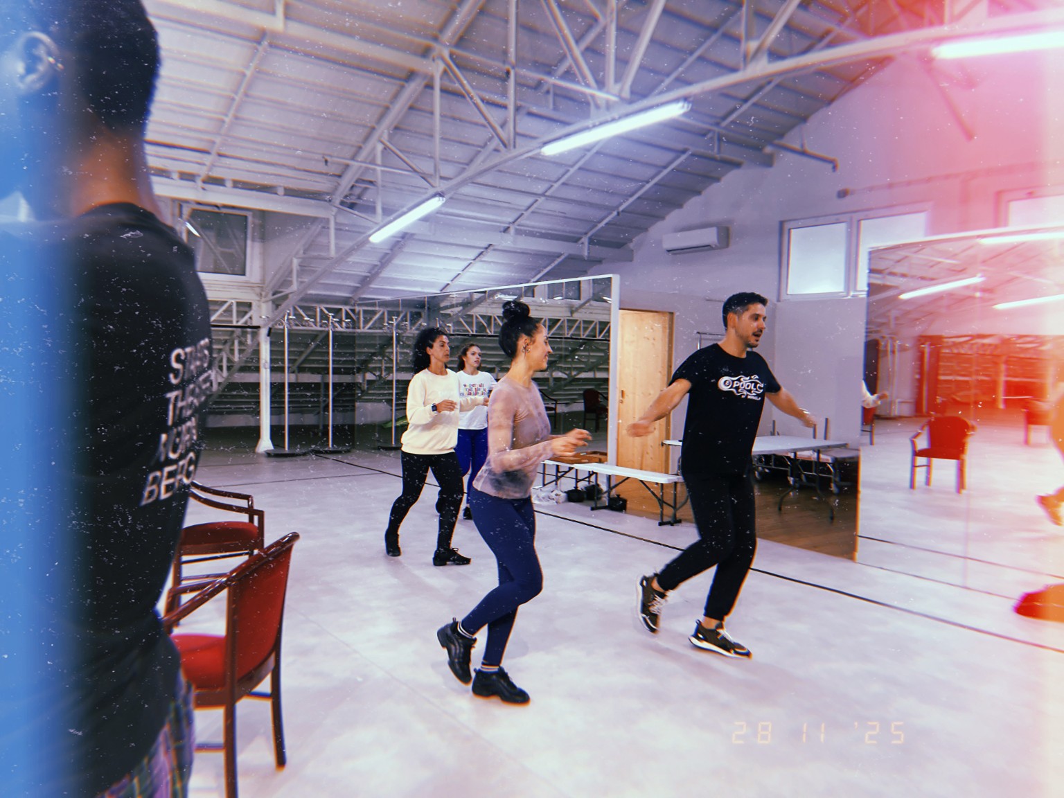 Marco Mercier demonstrating choreography with performers at rehearsal